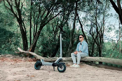 a jgh electric scooter parked on the sand