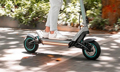 A close-up of a leg while riding a JGH electric scooter