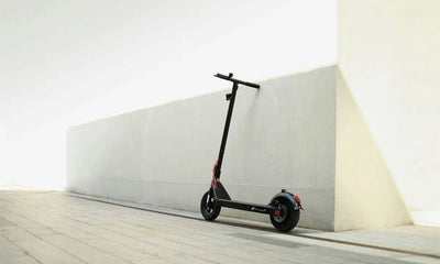 an electric scooter parked next to a wall