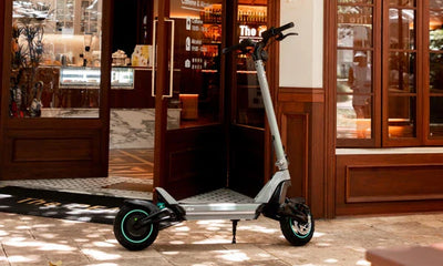 a jgh electric scooter parked in front of a cafe